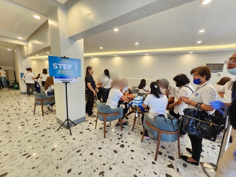 A YAKAP registration day with residents queuing at stations