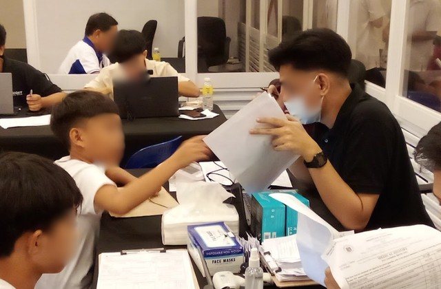 Young residents registering at a table