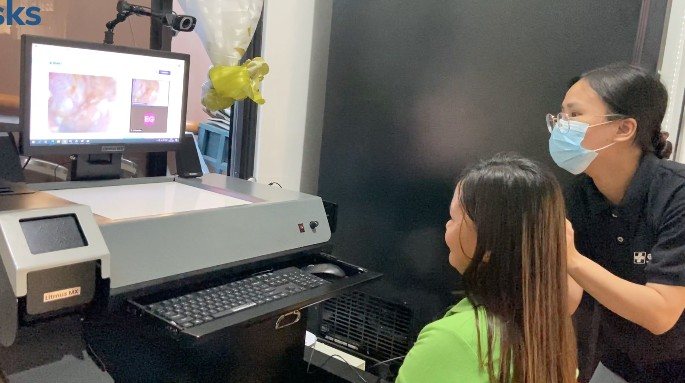 A health worker using a point-of-care exam station
